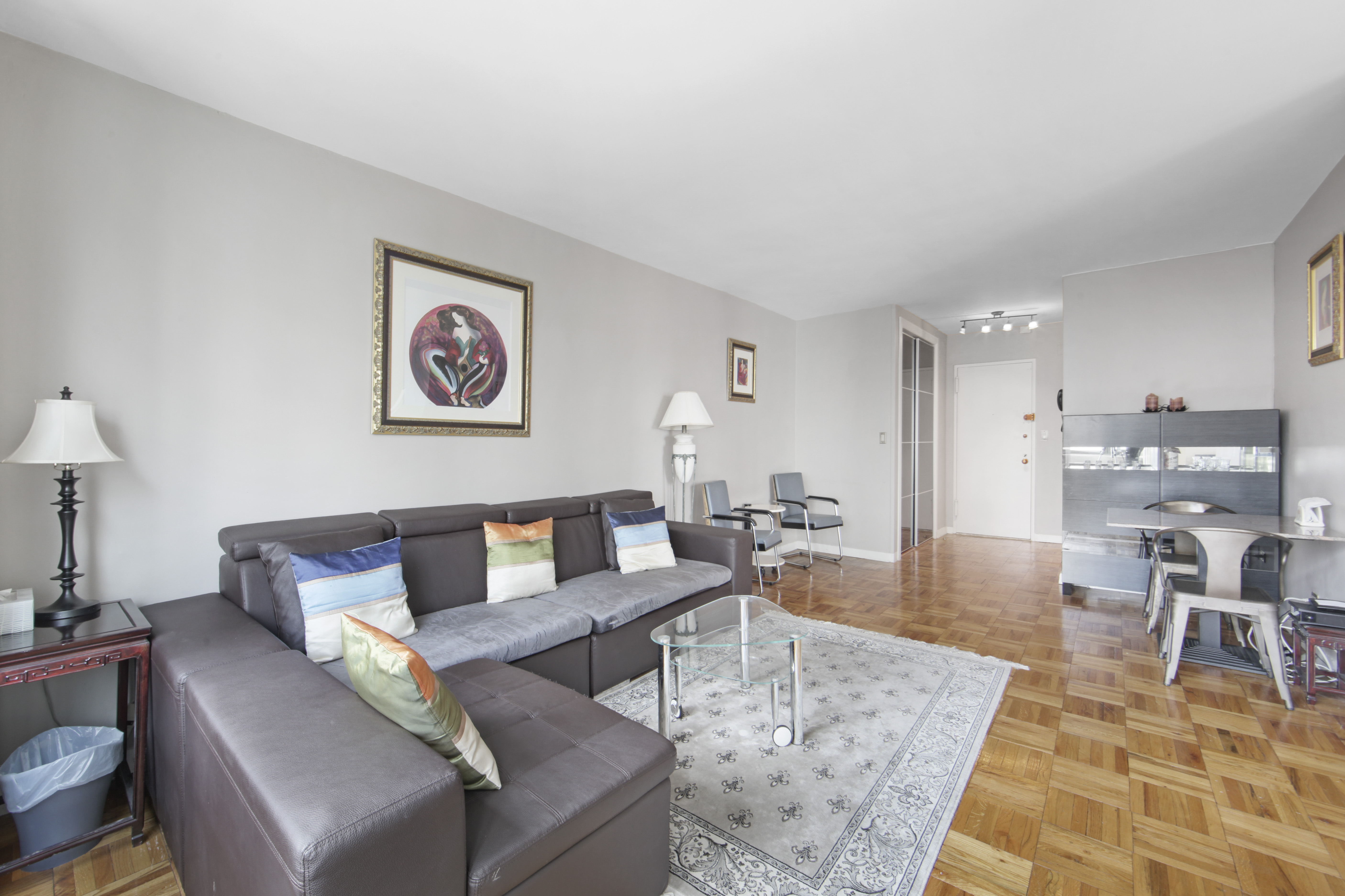 160 East 65th Street, Unit 8A Manhattan, NY 10065 - Photo 7 of 13 a living room with furniture and wooden floor