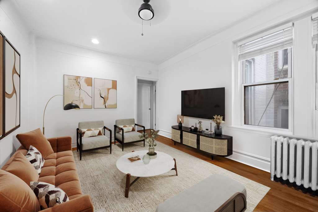 223 East 50th Street, Unit 6B Manhattan, NY 10022 - Photo 3 of 7 a living room with furniture and a flat screen tv