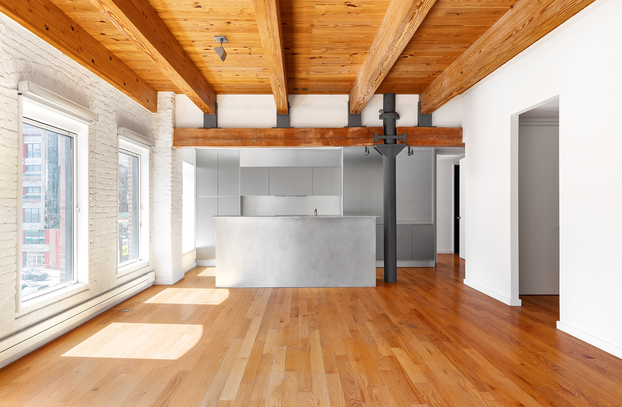 136 Baxter Street, Unit 3C Manhattan, NY 10013 - Photo 8 of 15 a view of a room with wooden floor and iron stairs
