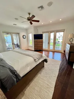 a spacious bathroom with a double vanity sink a mirror and a shower