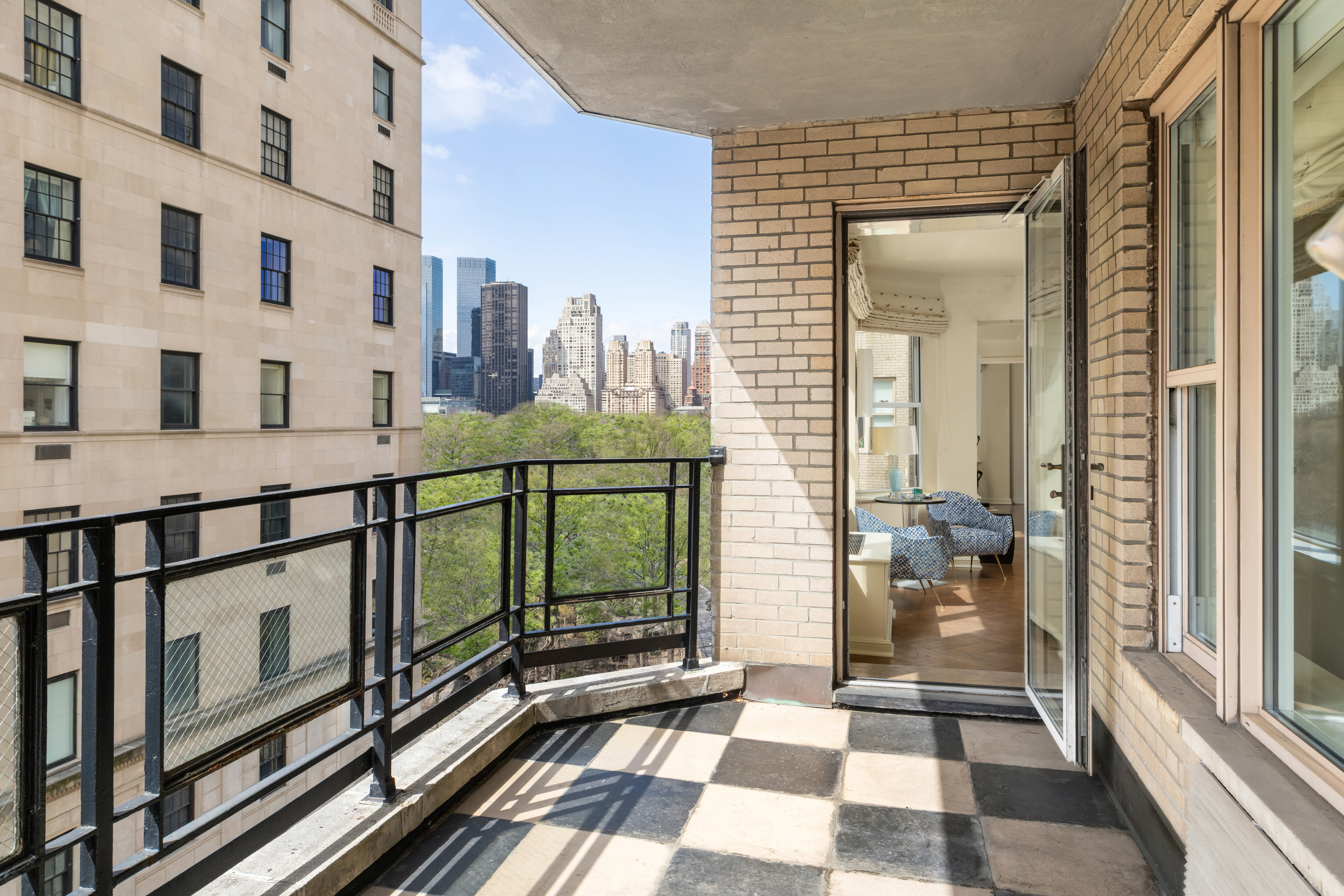 1 East 66th Street, Unit 9EF Manhattan, NY 10065 - Photo 5 of 19 a view of a balcony with wooden floor and a potted plant