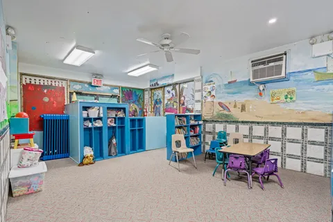 a bedroom with furniture and fan