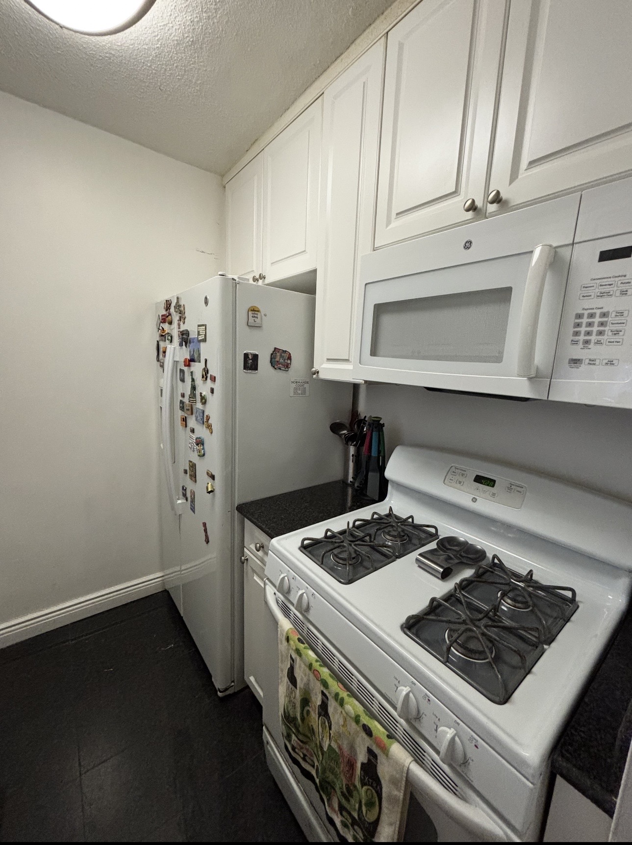 215 East 95th Street, Unit 19G Manhattan, NY 10128 - Photo 6 of 14 a stove top oven sitting inside of a kitchen