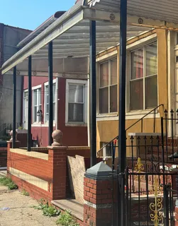 a front view of a house with outdoor seating