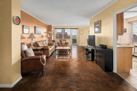 a living room with furniture large window and flat screen tv