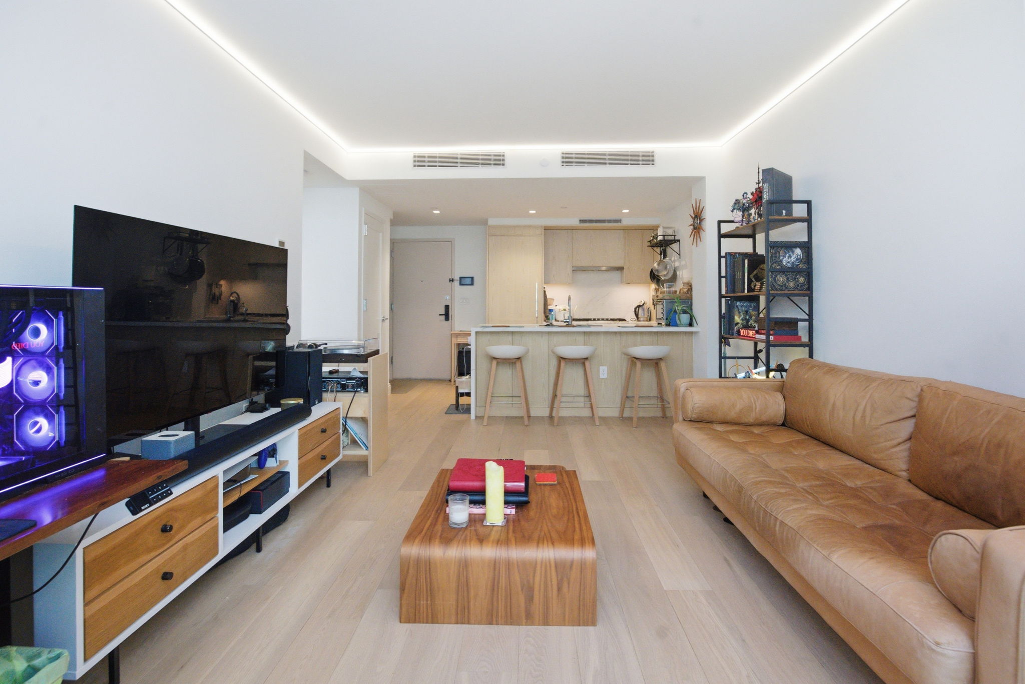 37-14 34th Street, Unit N3E Queens, NY 11101 - Photo 4 of 18 a living room with furniture and a flat screen tv
