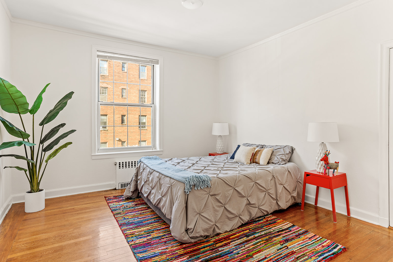 37-51 84th Street, Unit 21 Queens, NY 11372 - Photo 4 of 10 a bedroom with a bed and a window