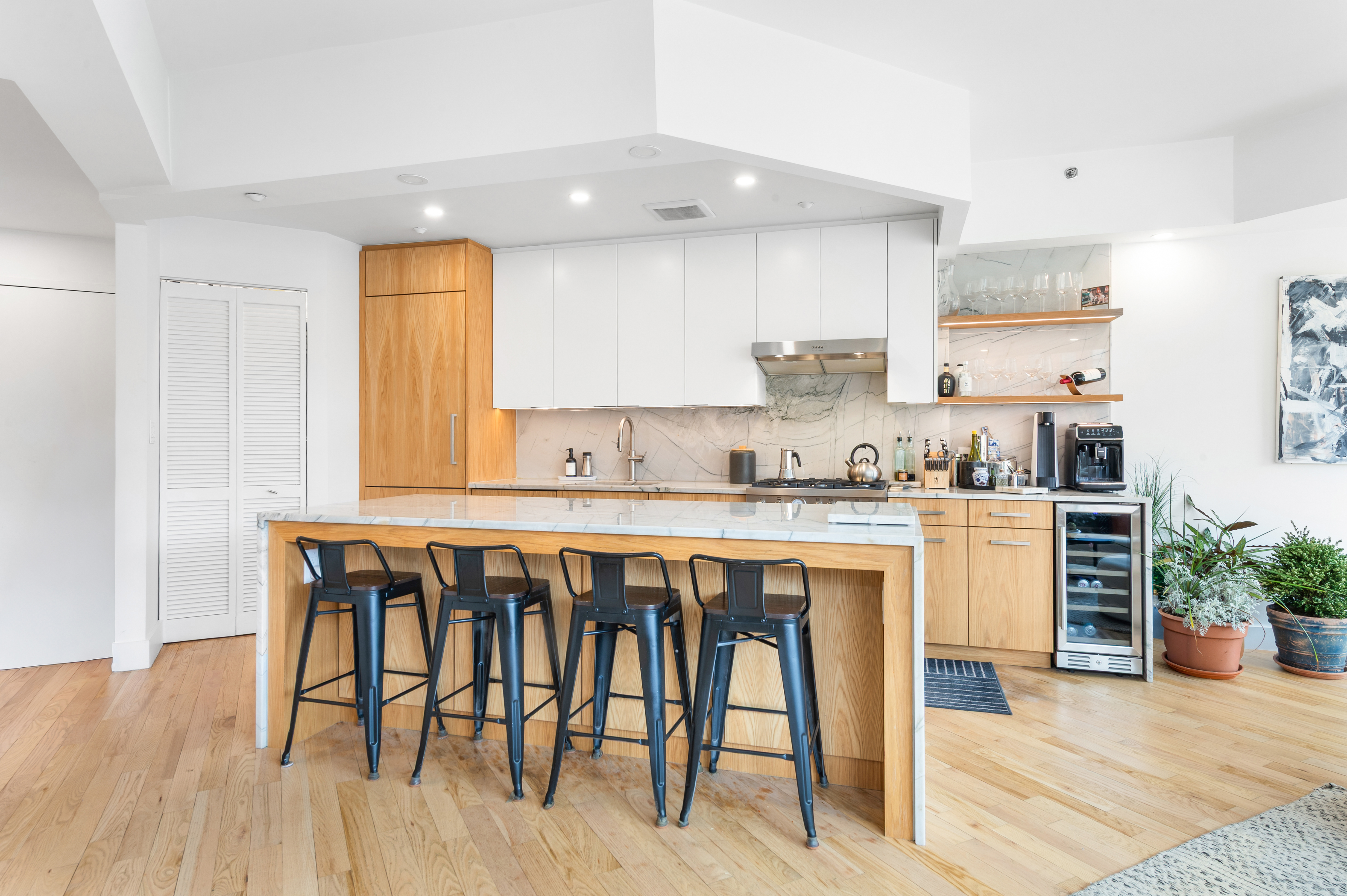 2110 Frederick Douglass Boulevard, Unit 4C Manhattan, NY 10026 - Photo 4 of 19 a kitchen with a table chairs sink and cabinets