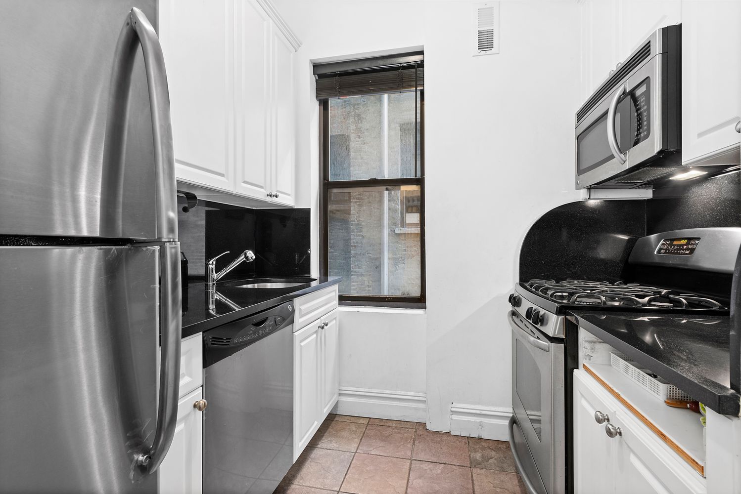 63 West 107th Street, Unit 33 Manhattan, NY 10025 - Photo 3 of 5 a kitchen with a stove and a refrigerator