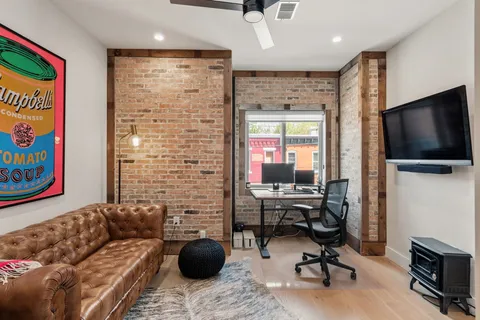 a bedroom with a bed a couch and a window