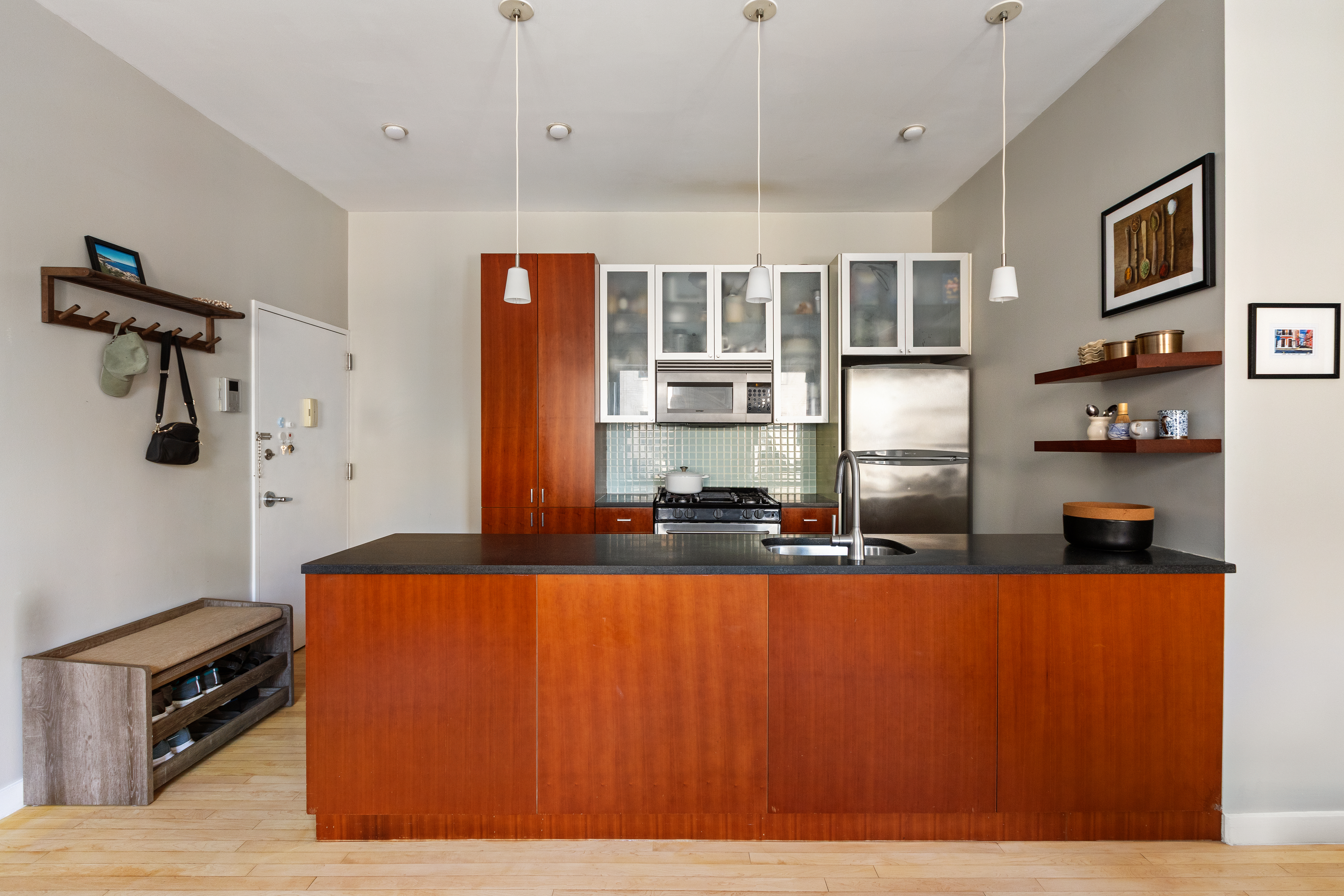 524 St Johns Place, Unit 2A Brooklyn, NY 11238 - Photo 3 of 8 a large kitchen with stainless steel appliances granite countertop a refrigerator a stove and a wooden floors