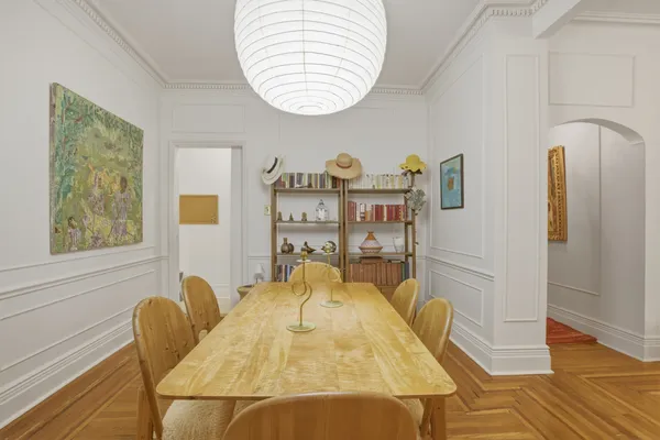 a view of a dining room with furniture and a window