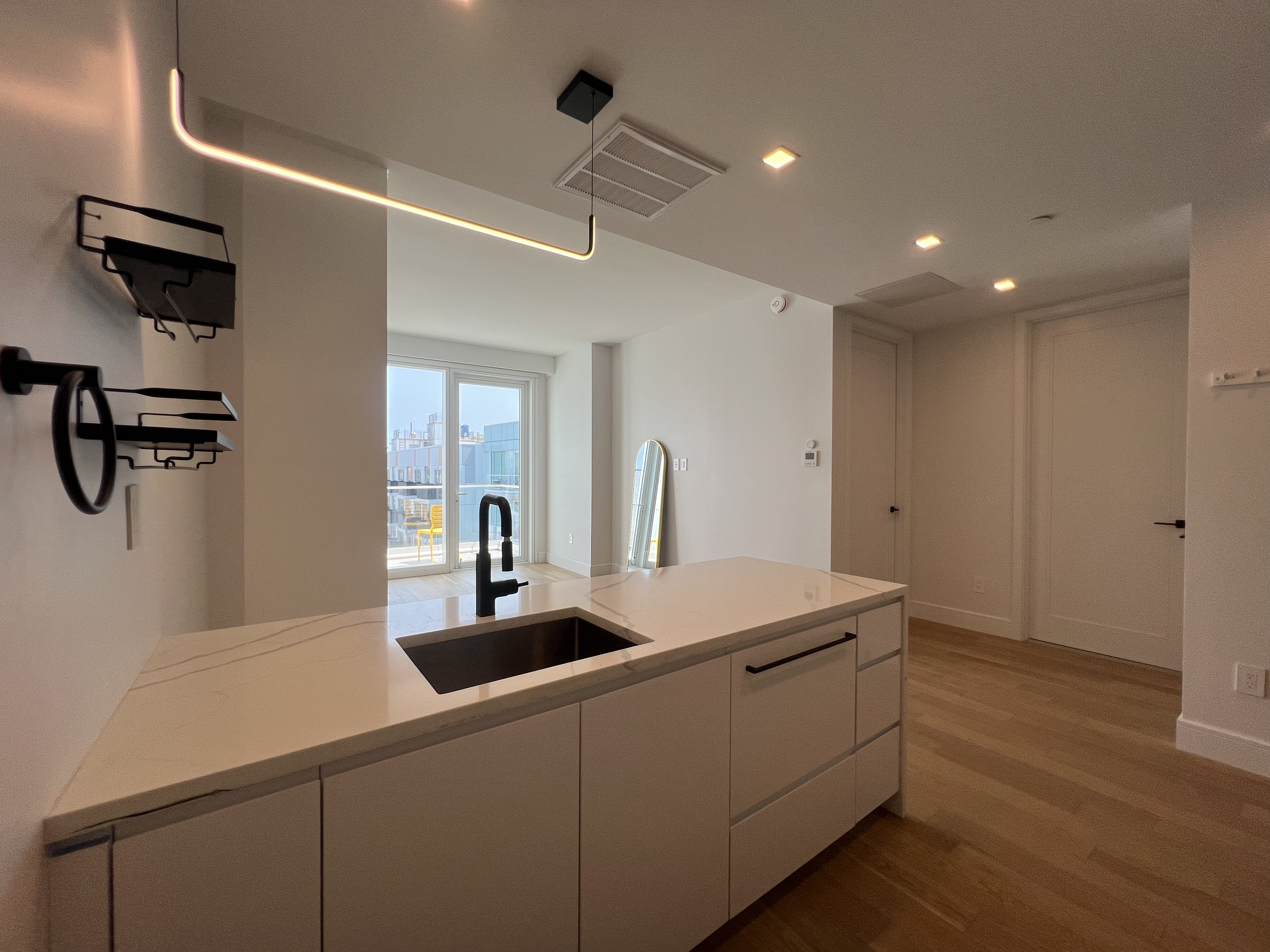 37-34 33rd Street, Unit 7H Queens, NY 11101 - Photo 2 of 18 a room with a table chairs and wooden floor