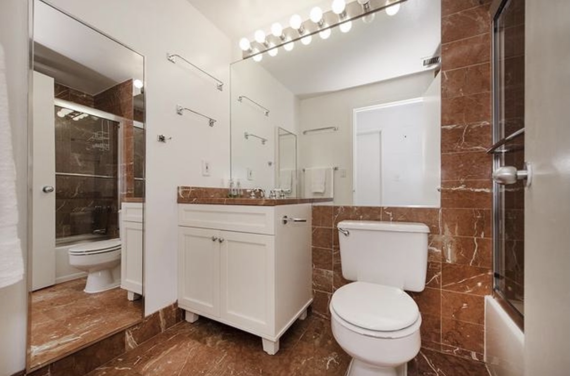 201 West 74th Street, Unit 16A Manhattan, NY 10023 - Photo 6 of 13 a bathroom with a toilet sink and shower