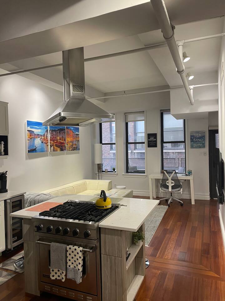 43-45 East 30th Street, Unit 8D Manhattan, NY 10016 - Photo 3 of 11 a kitchen with a stove and wooden floor