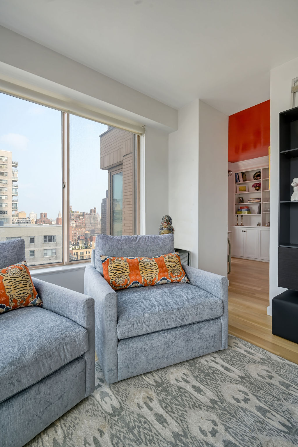 200 East 69th Street, Unit 21C Manhattan, NY 10021 - Photo 6 of 16 a bedroom with large window and a couch