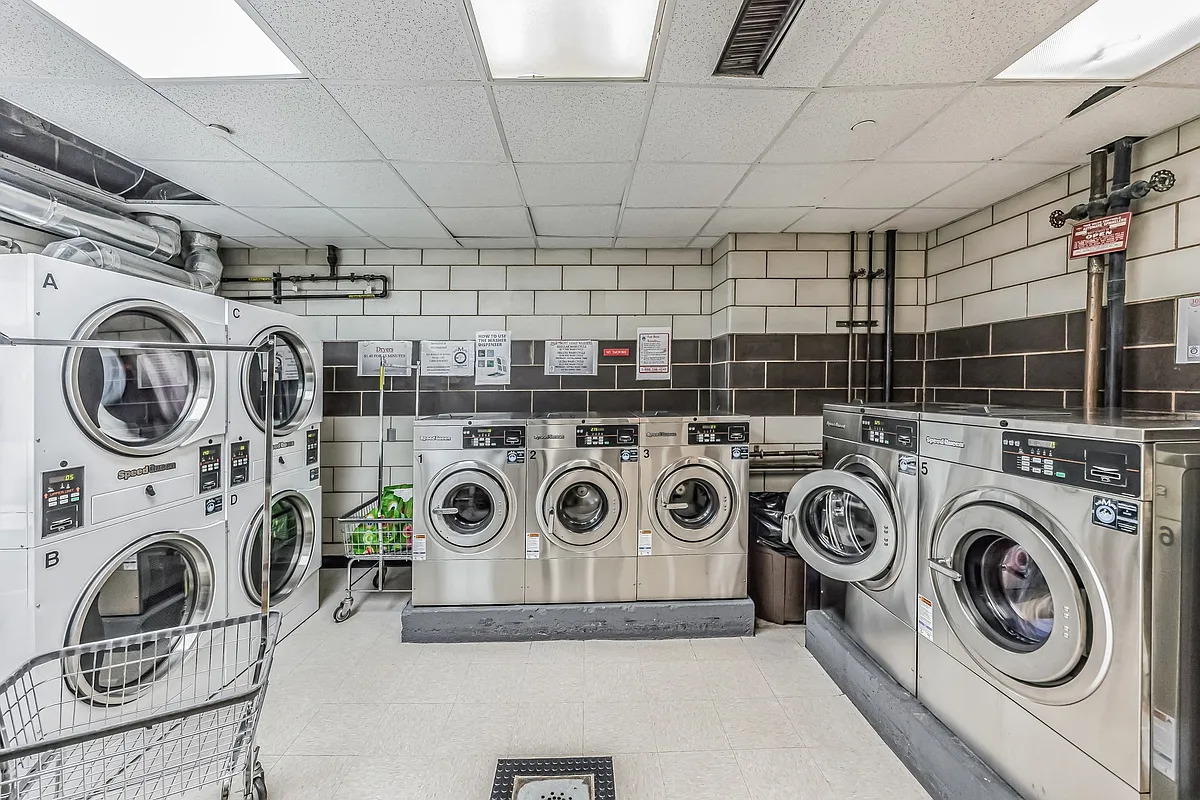 301 East 45th Street, Unit 8A Manhattan, NY 10017 - Photo 7 of 11 a utility room with dryer washer and other items