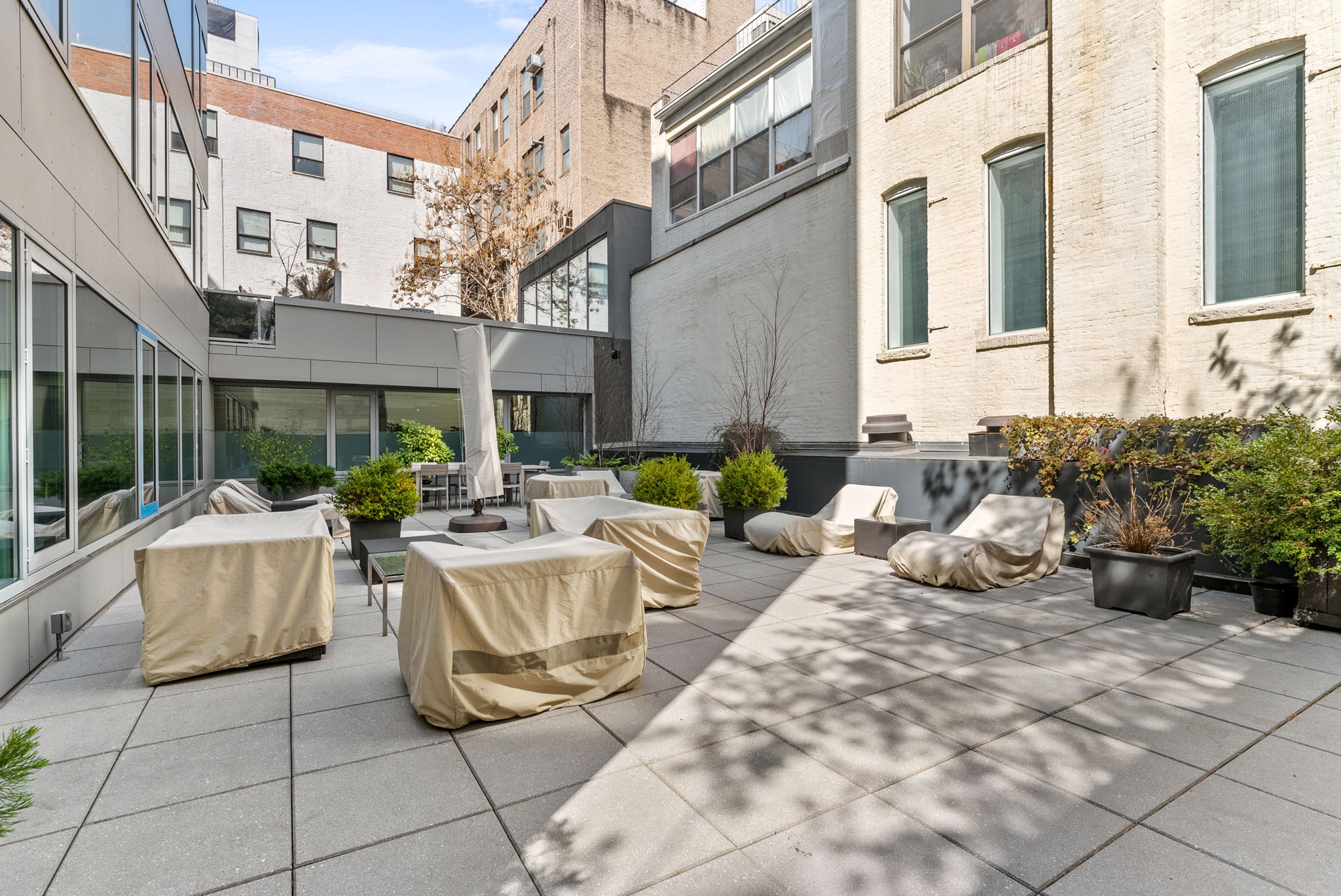 425 West 53rd Street, Unit 416 Manhattan, NY 10019 - Photo 17 of 19 a view of a patio with couches and a potted plant