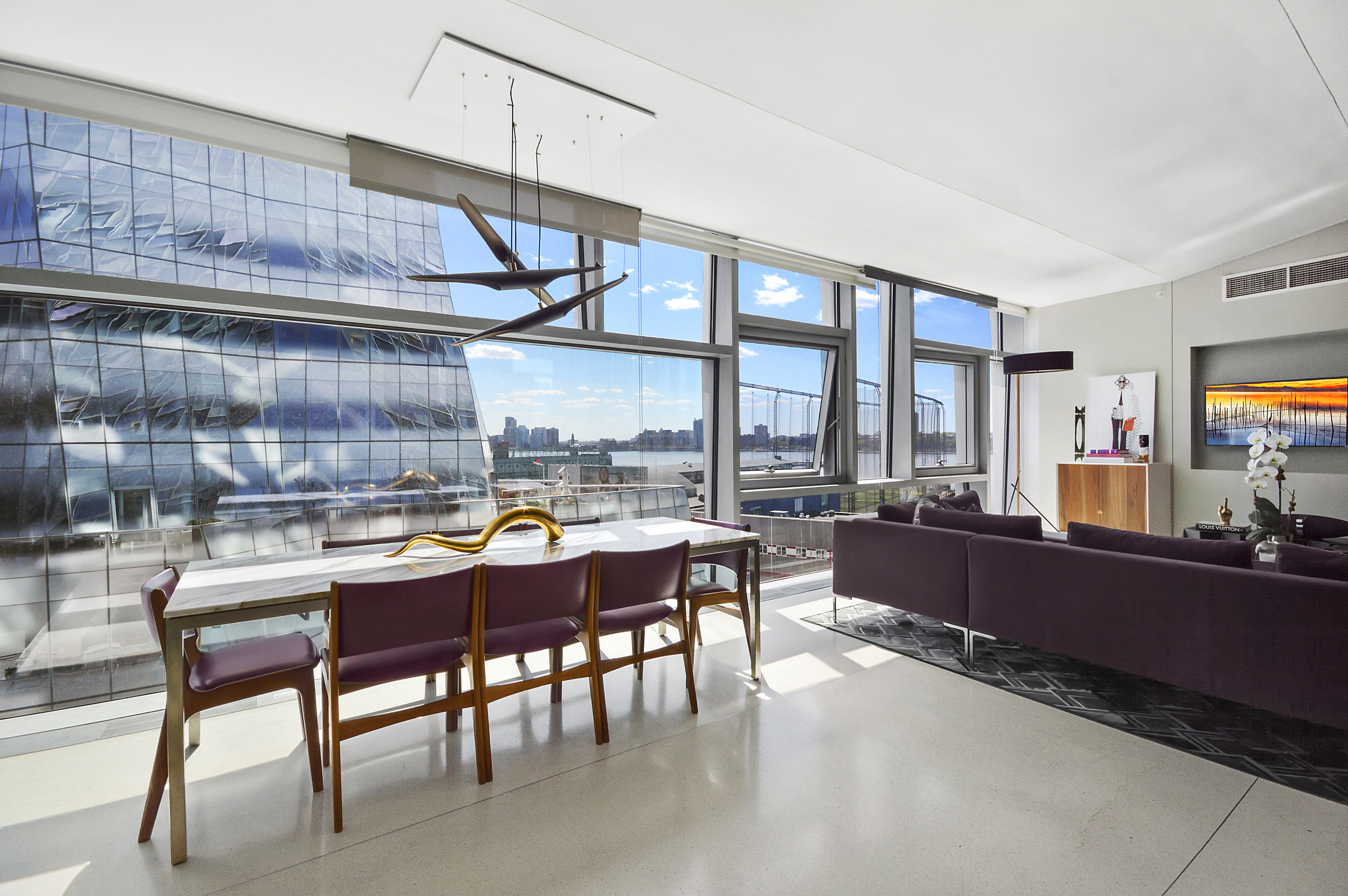 100 11th Avenue, Unit 9D Manhattan, NY 10011 - Photo 4 of 17 a room with furniture a large window and a table