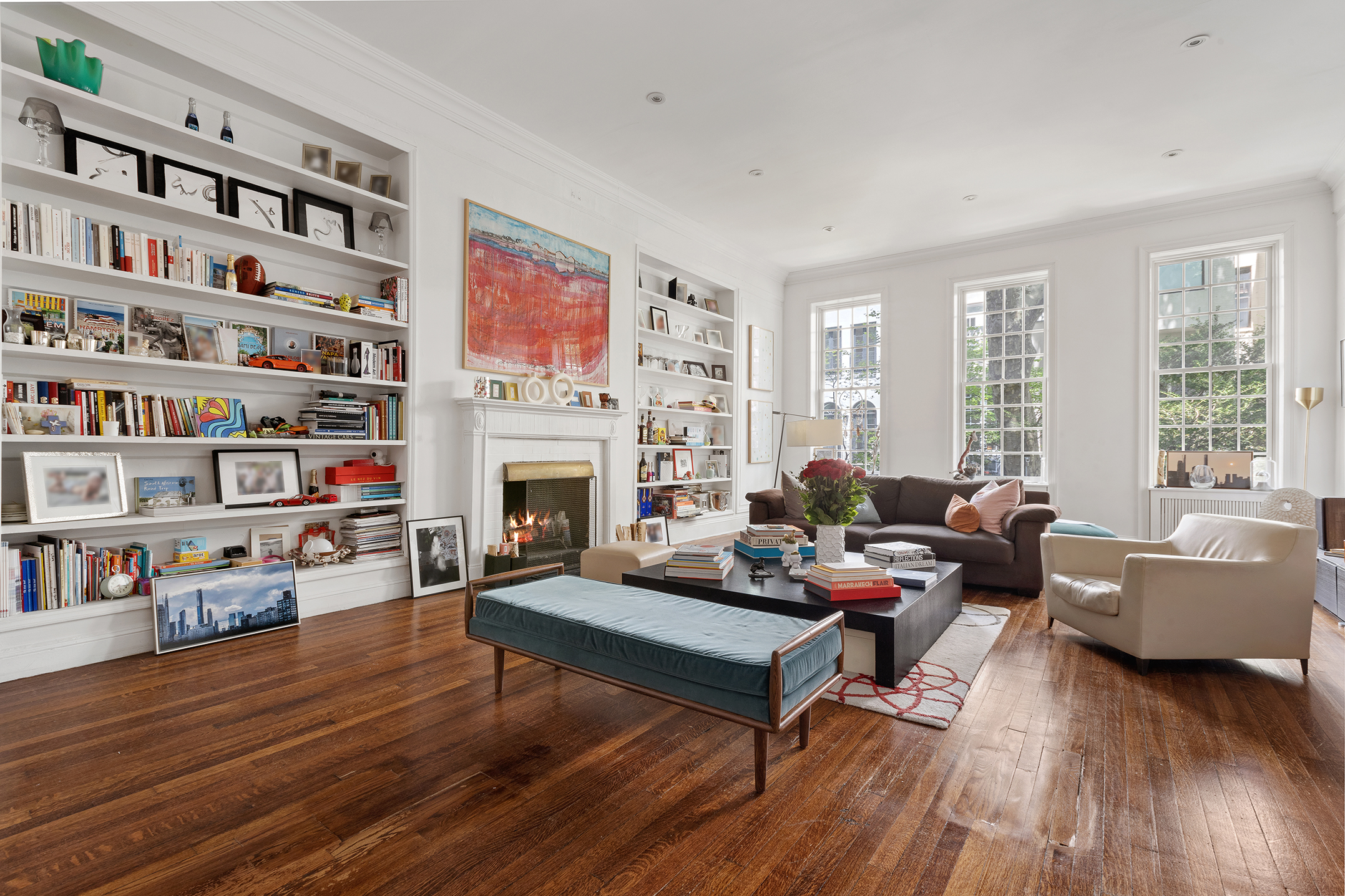 159 East 63rd Street, Unit 2/3 Manhattan, NY 10065 - Photo 1 of 13 a living room with furniture fireplace and a book shelf