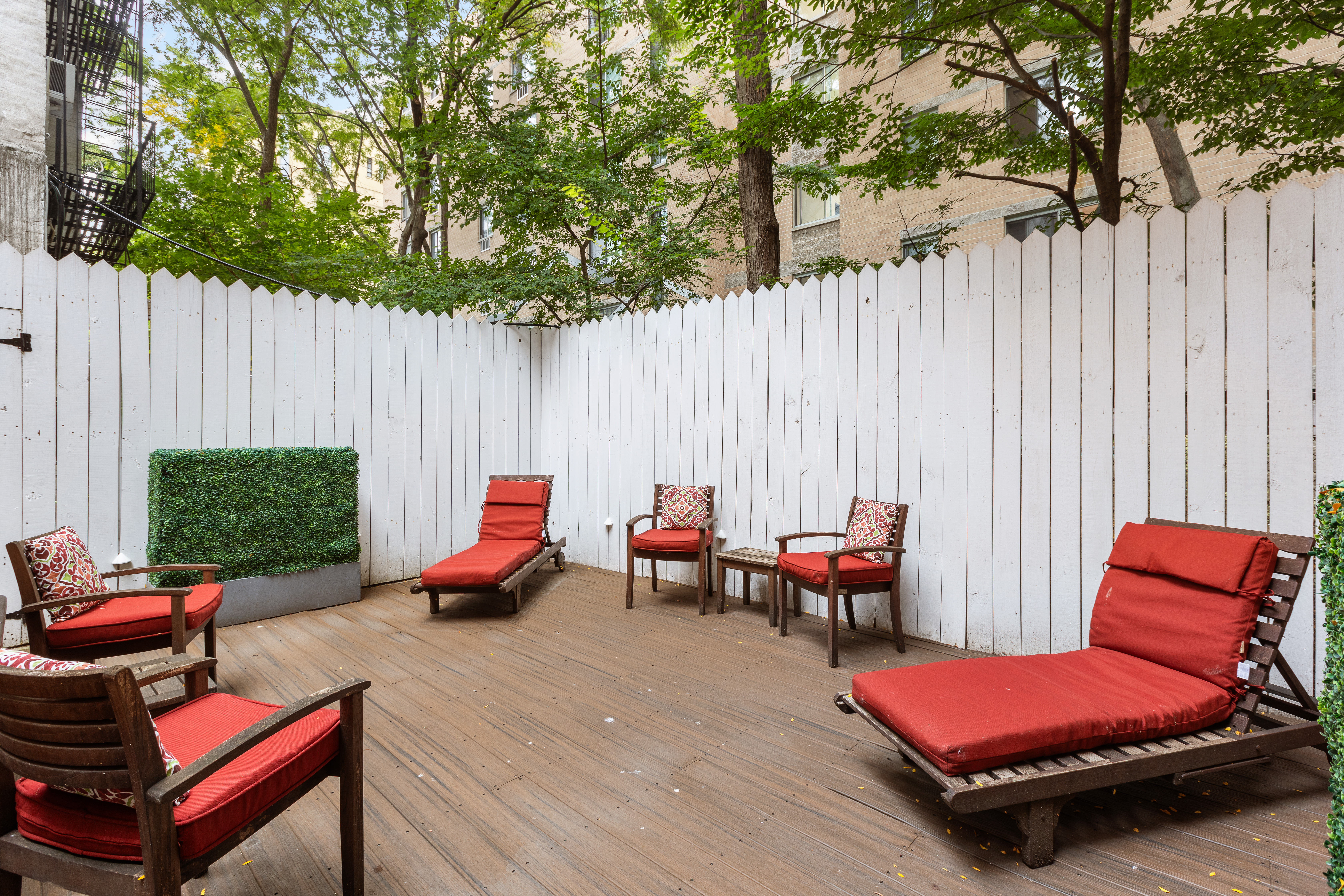 203 East 7th Street, Unit 2 Manhattan, NY 10009 - Photo 9 of 9 a swimming pool with lawn chairs and wooden fence
