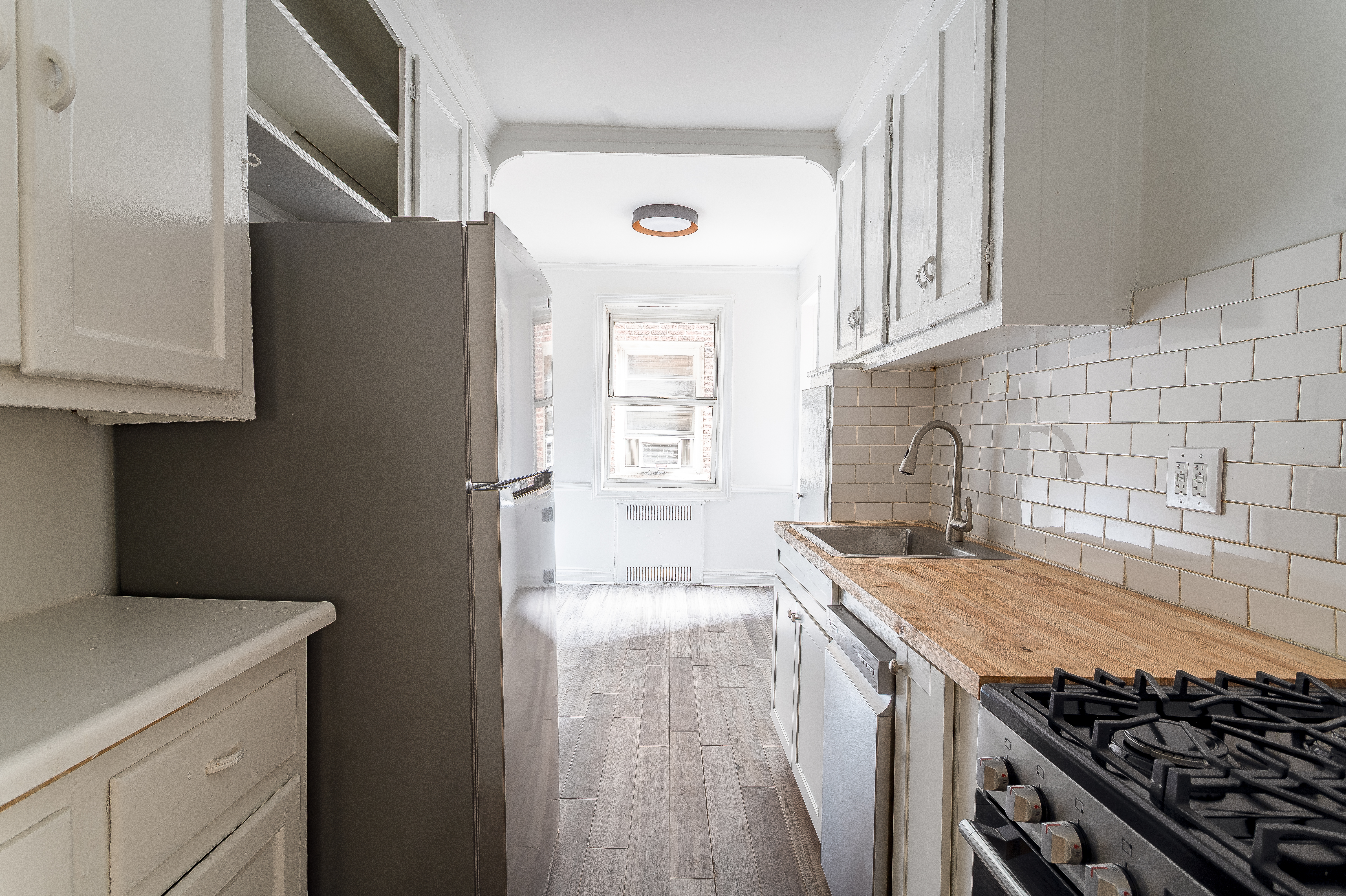 40 Tehama Street, Unit 2E Brooklyn, NY 11218 - Photo 8 of 12 a kitchen with a stove and a refrigerator