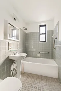 a bathroom with a sink a toilet and bathtub