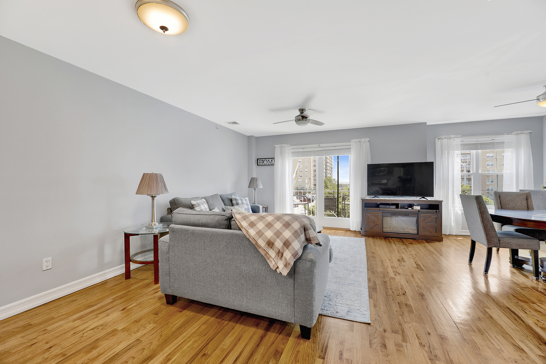 102-20 Rockaway Beach Boulevard, Unit 3C Queens, NY 11694 - Photo 9 of 36 a living room with furniture and a flat screen tv
