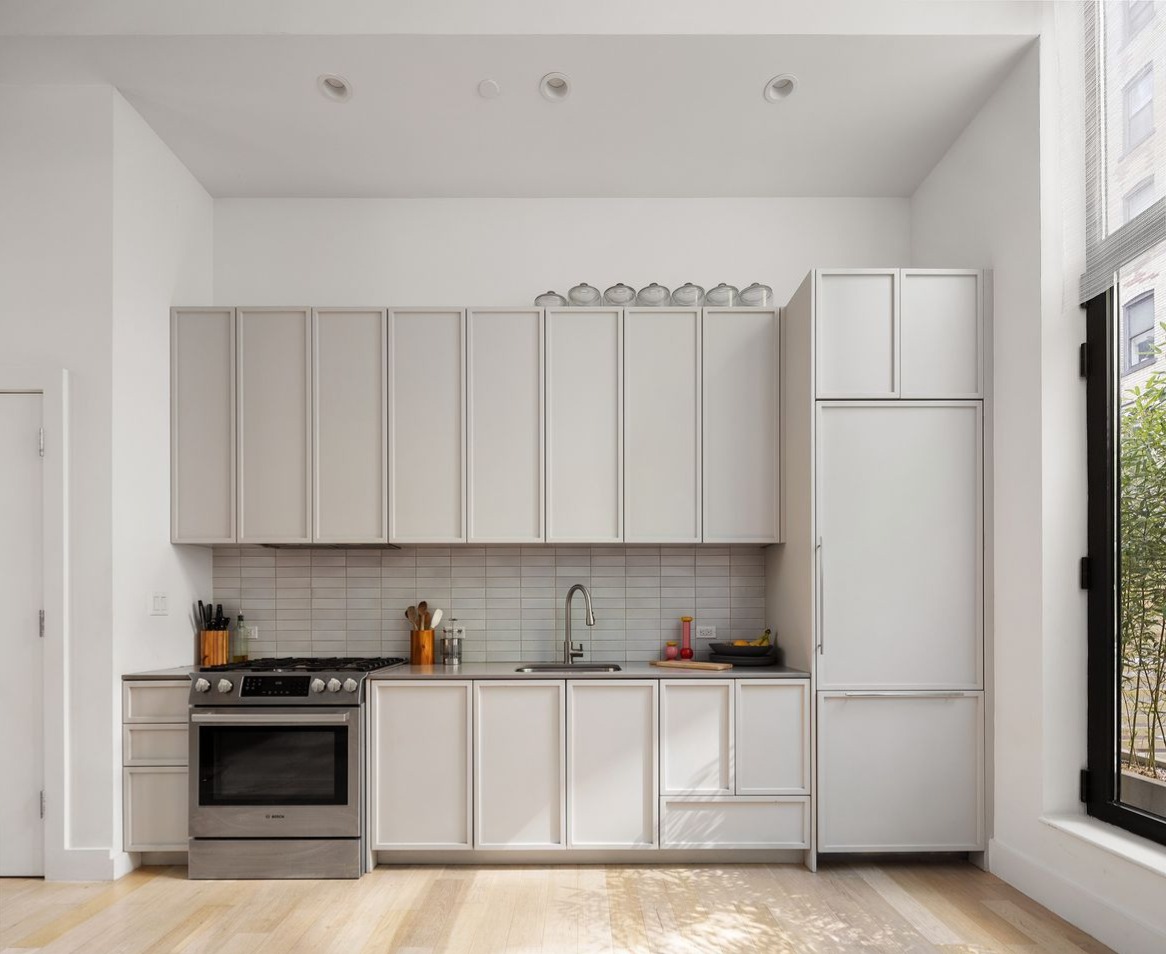 111 Montgomery Street, Unit GARDEN 1B Brooklyn, NY 11225 - Photo 3 of 14 a kitchen with stainless steel appliances granite countertop a refrigerator sink stove and white cabinets