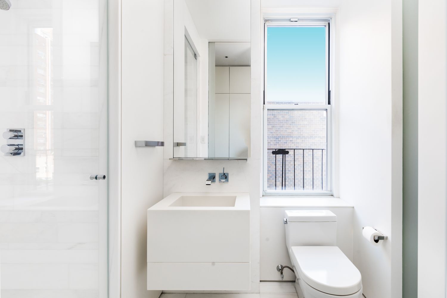876 Park Avenue, Unit 7N Manhattan, NY 10075 - Photo 16 of 21 a bathroom with a toilet a sink and a mirror