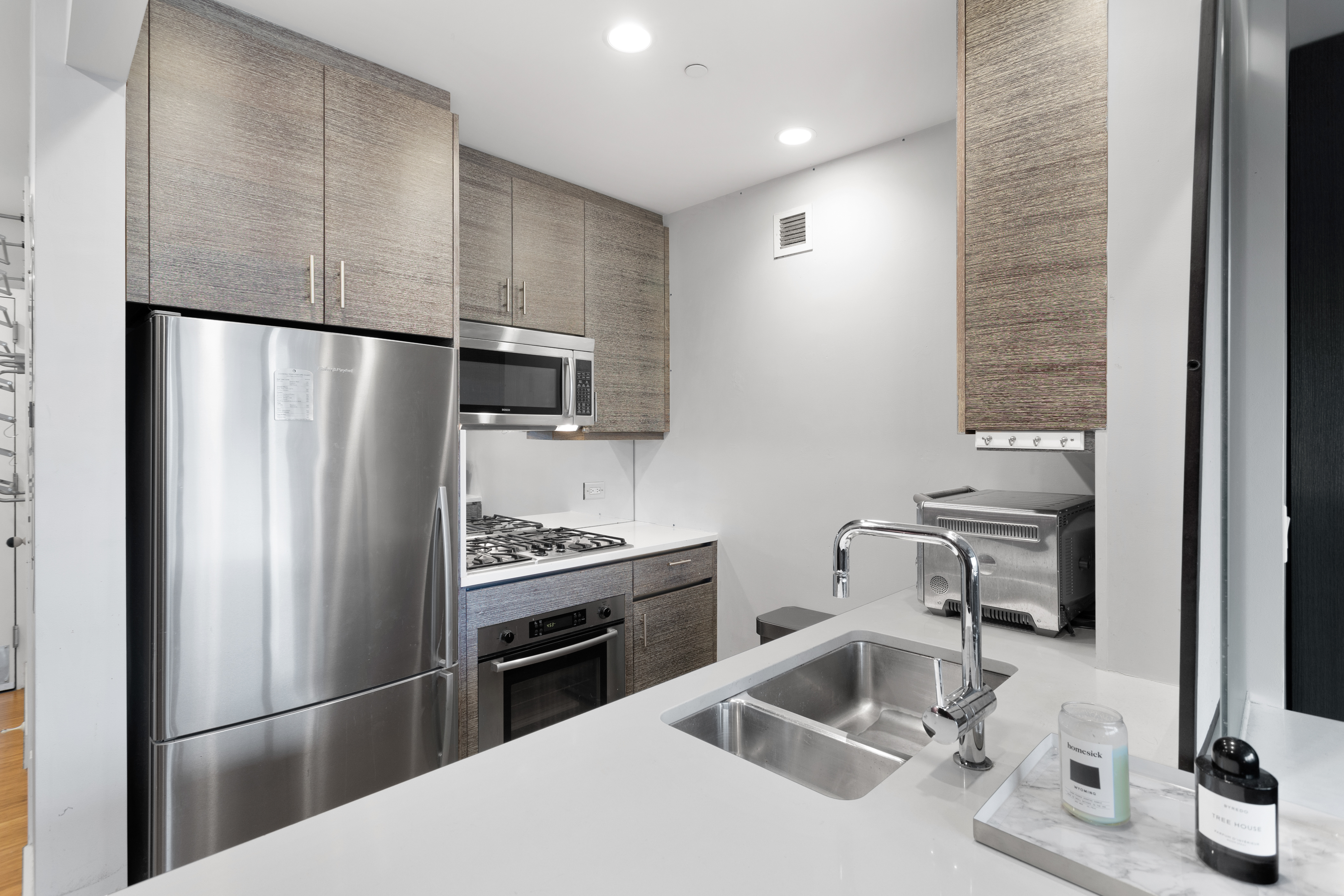 305 West 16th Street, Unit 5B Manhattan, NY 10011 - Photo 4 of 15 a kitchen with a refrigerator sink and microwave