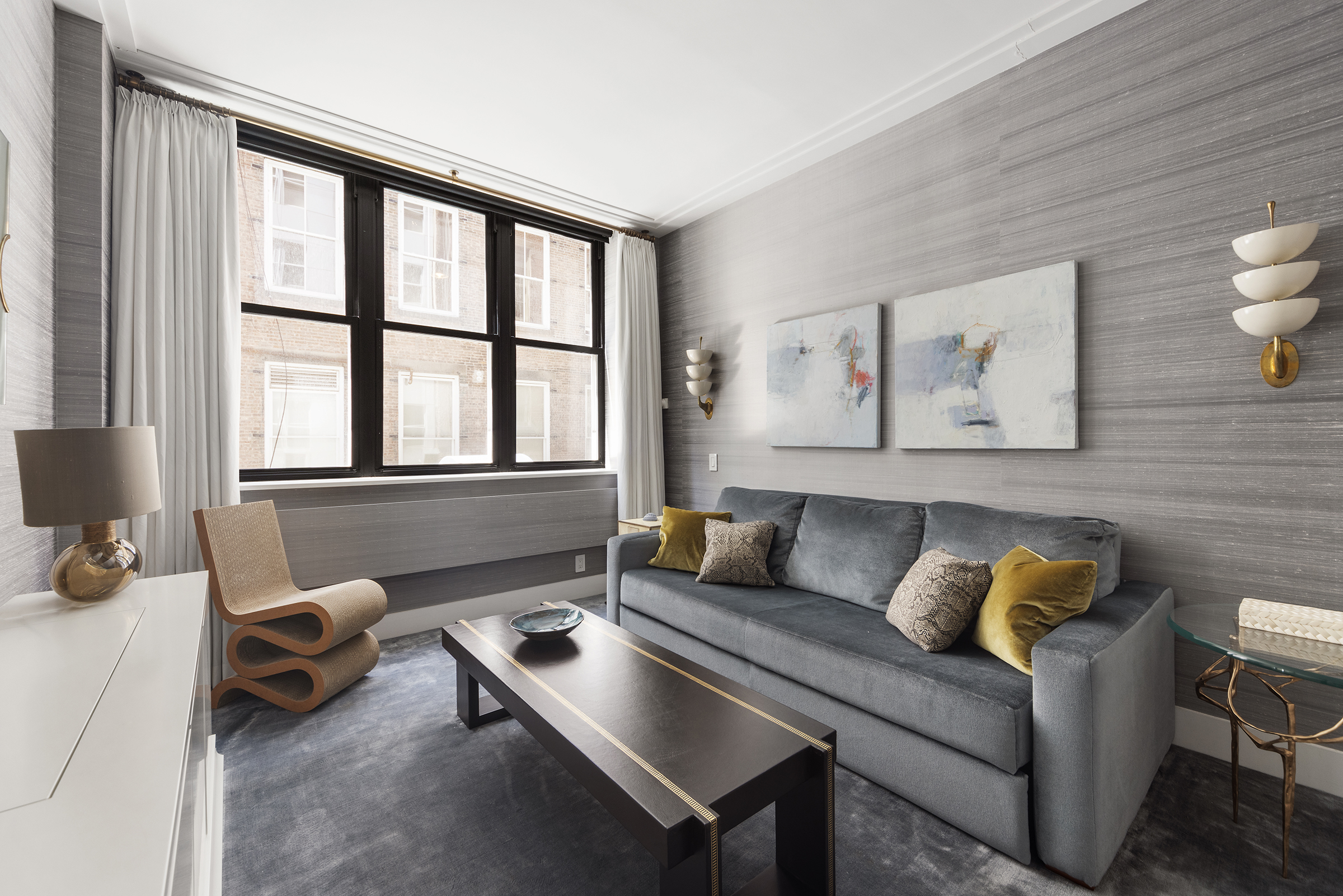 109 Greene Street, Unit 2C Manhattan, NY 10012 - Photo 4 of 13 a living room with furniture and a large window