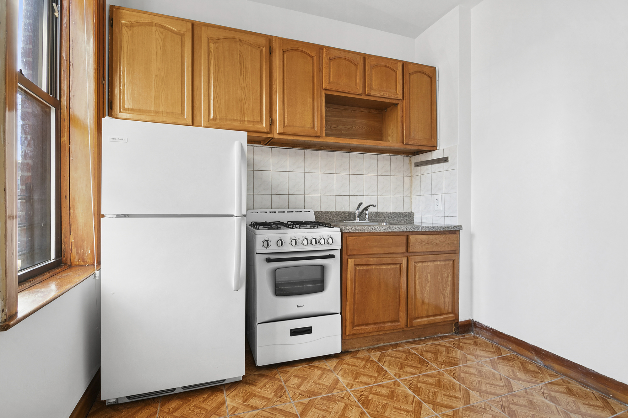 275 Schaefer Street, Unit 2F Brooklyn, NY 11237 - Photo 3 of 4 a kitchen with stainless steel appliances granite countertop a refrigerator and a stove top oven