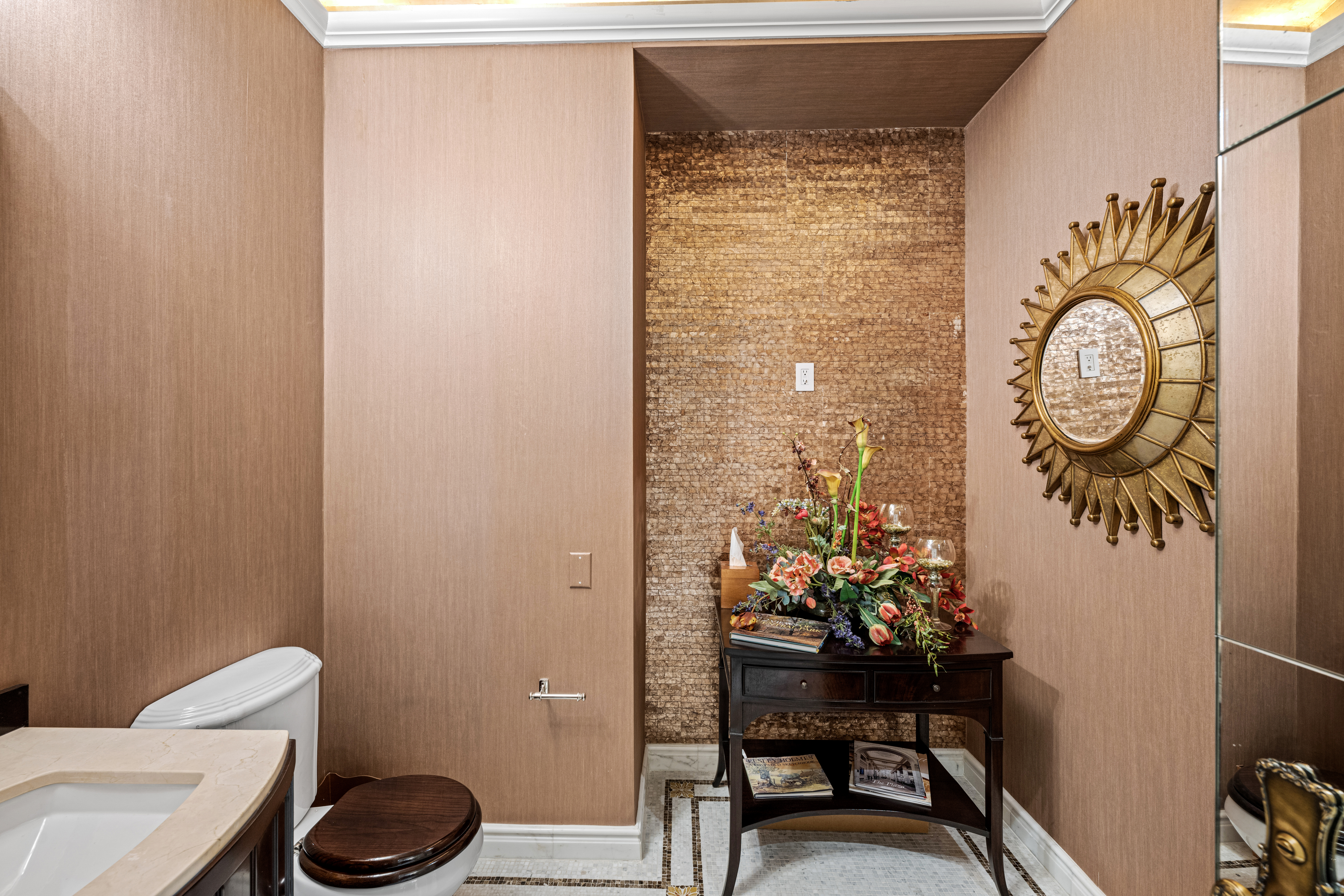 1 Central Park South, Unit 1013 Manhattan, NY 10019 - Photo 15 of 32 a bathroom with a toilet a sink and a mirror