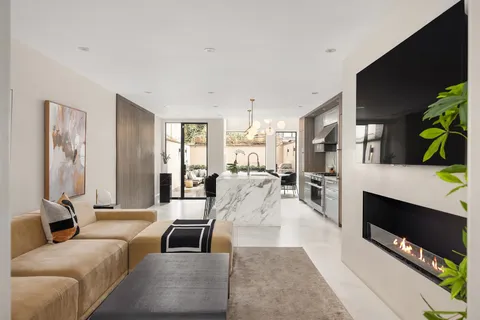 a kitchen with stainless steel appliances kitchen island granite countertop a stove a sink and a refrigerator