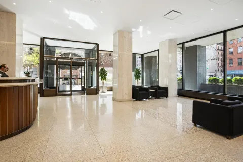 a lobby with furniture and large windows