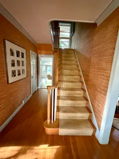 a view of an entryway with wooden floor and stairs