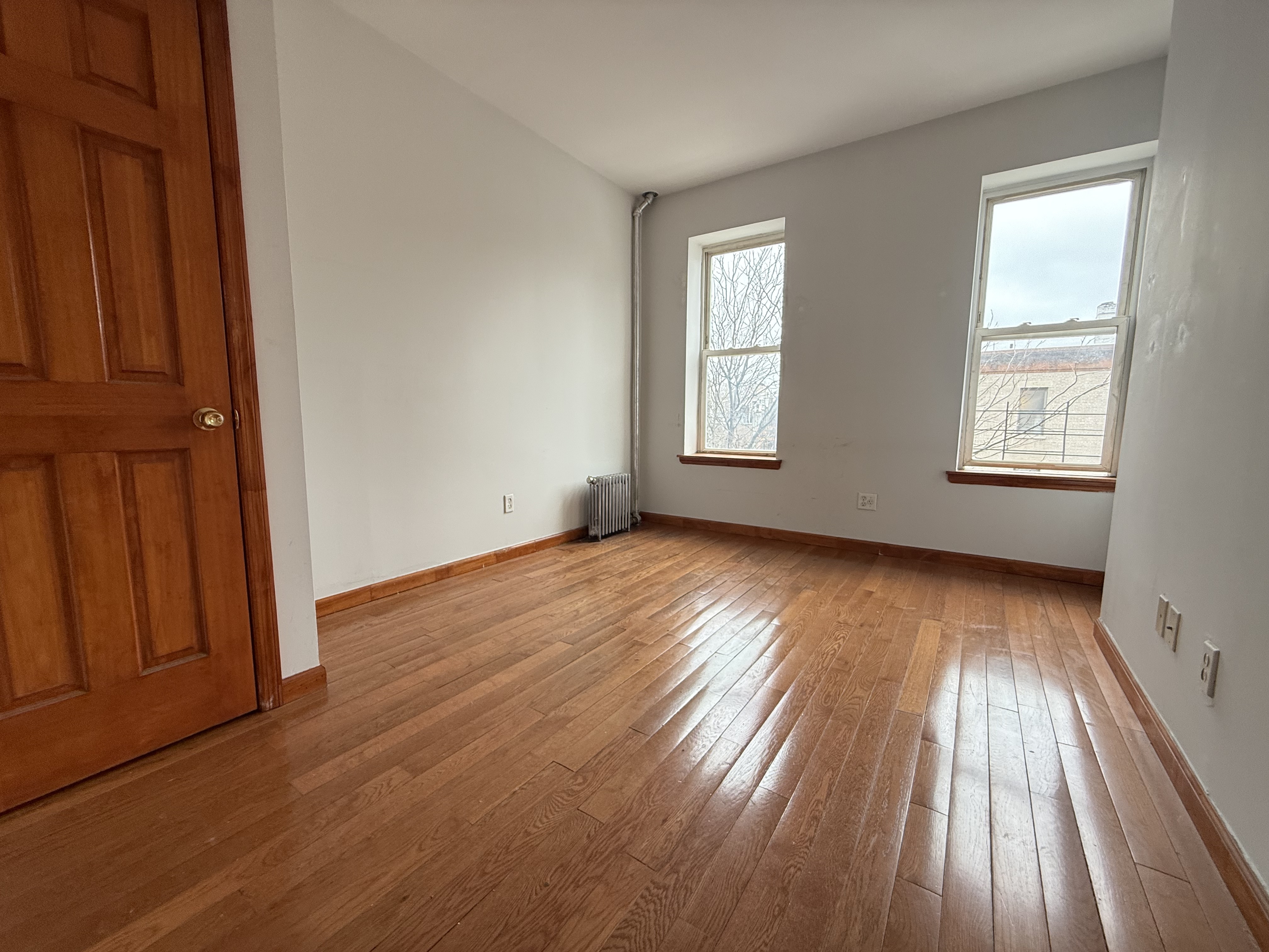 386 Prospect Place Brooklyn, NY 11238 - Photo 7 of 7 an empty room with wooden floor and windows