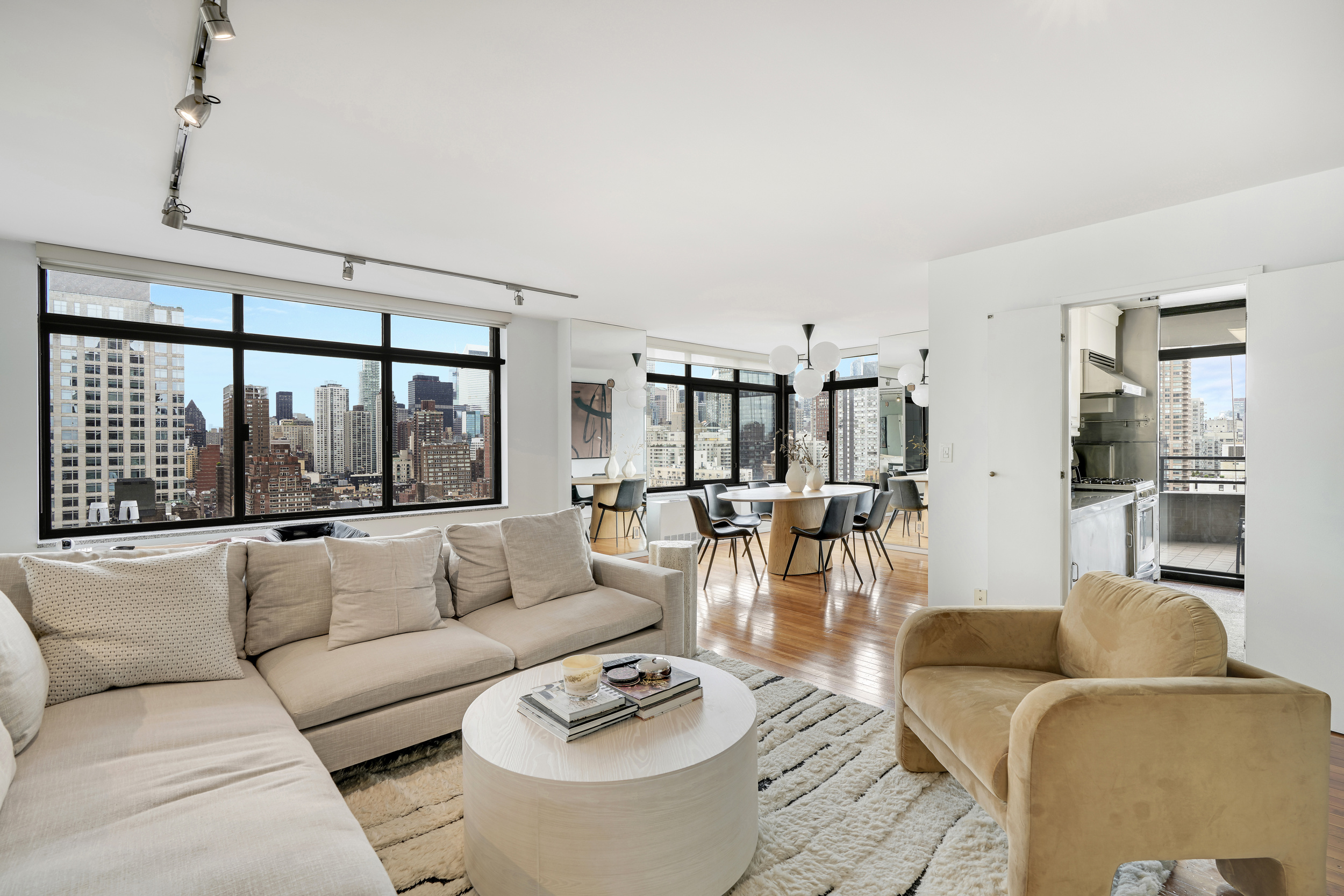 400 East 70th Street, Unit 2402 Manhattan, NY 10021 - Photo 1 of 18 a living room with furniture and a large window