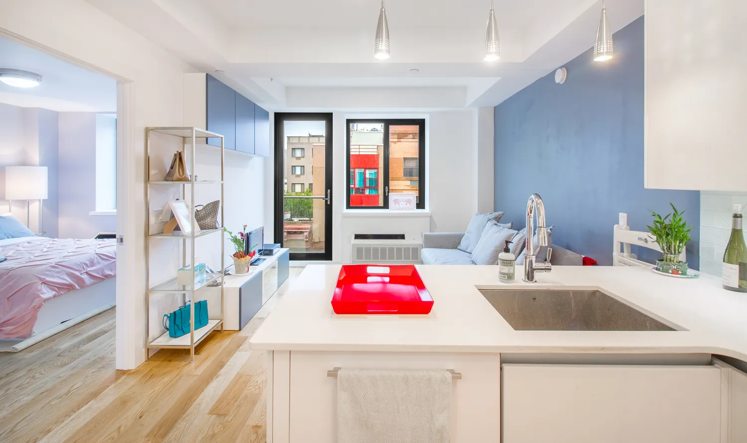 a kitchen with a sink dishwasher and a refrigerator with wooden floor