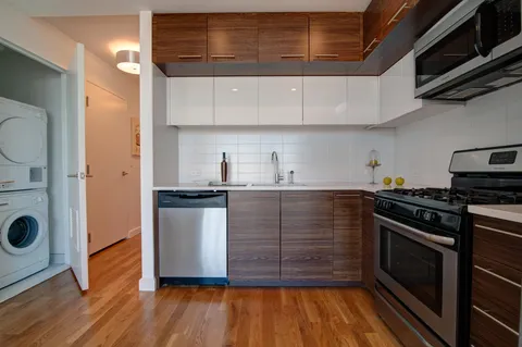 a kitchen with stainless steel appliances granite countertop a stove and a refrigerator