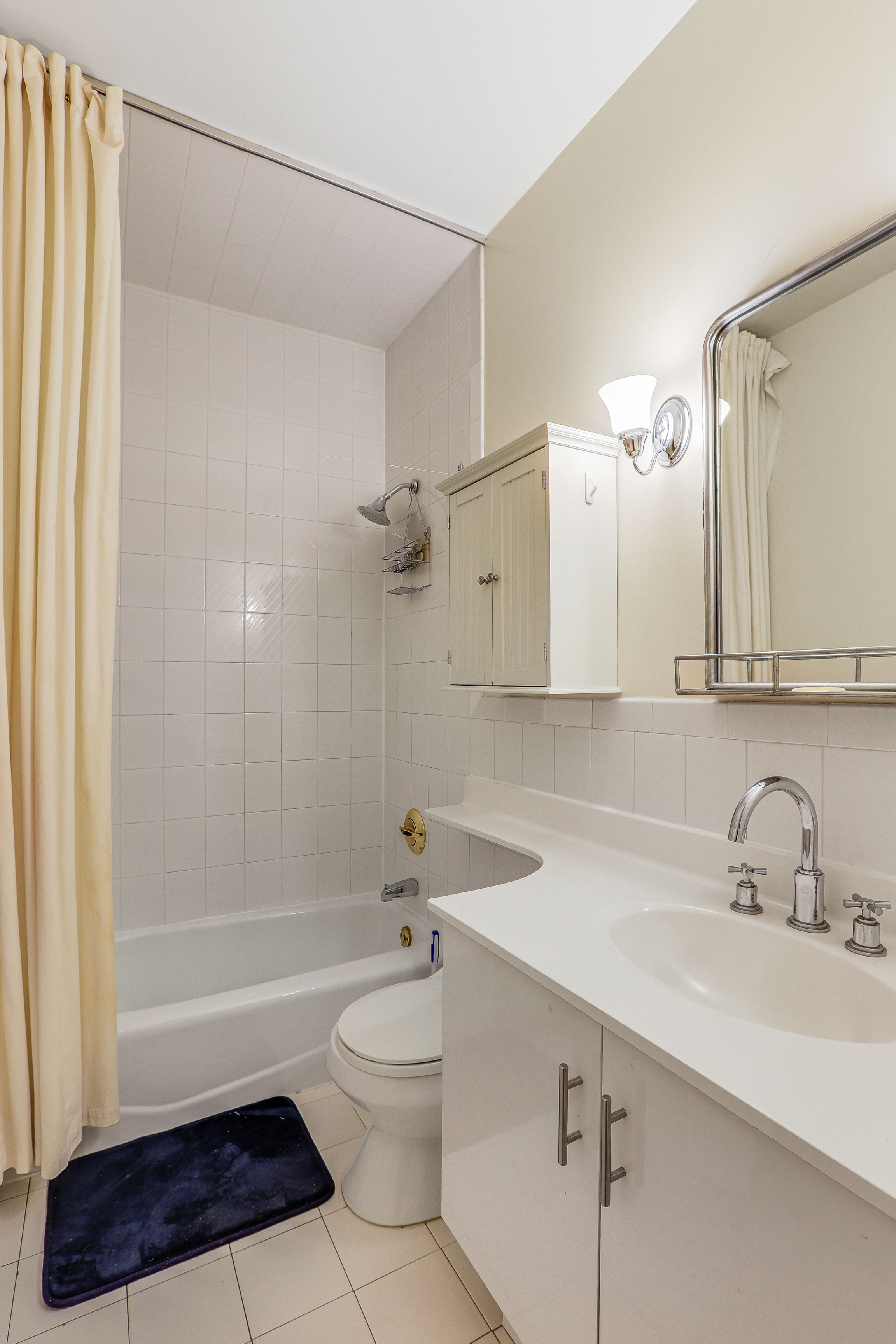 136-140 West 23rd Street, Unit 4CC Manhattan, NY 10011 - Photo 13 of 14 a bathroom with a sink a toilet and shower