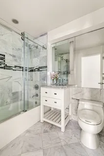 a bathroom with a toilet a sink and a mirror
