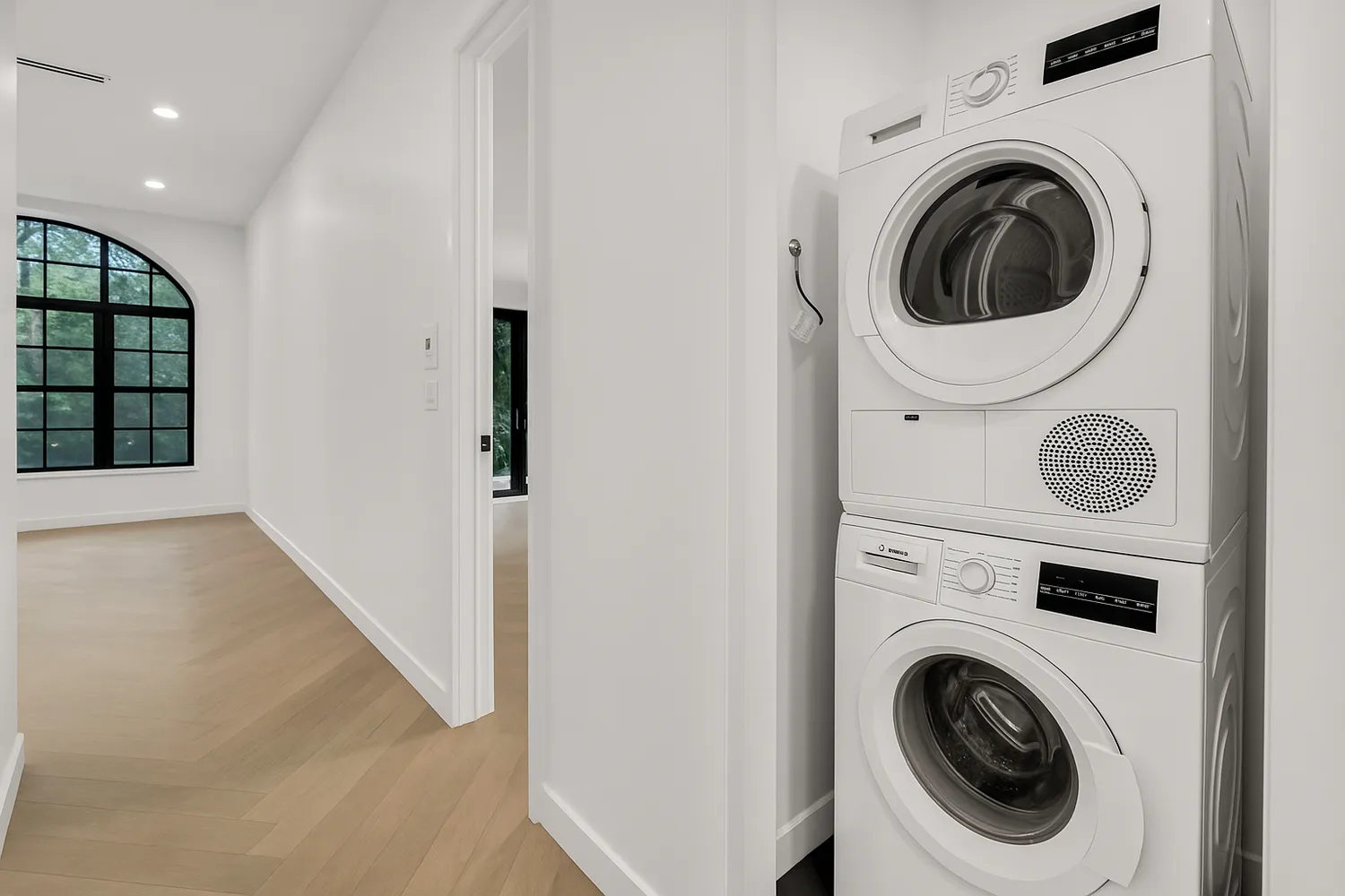 a view of a hallway with washer and dryer