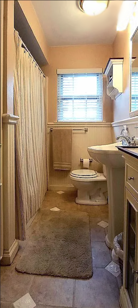 316 Classen Drive Dallas, TX 75218 - Photo 5 of 9 a bathroom with a sink a mirror and a window