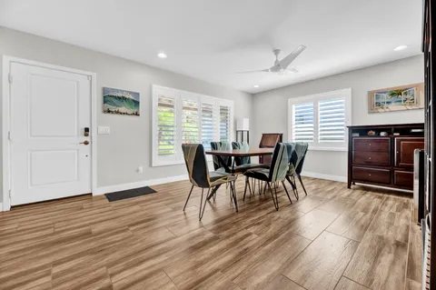 a view of a dining room with furniture window and wooden floor