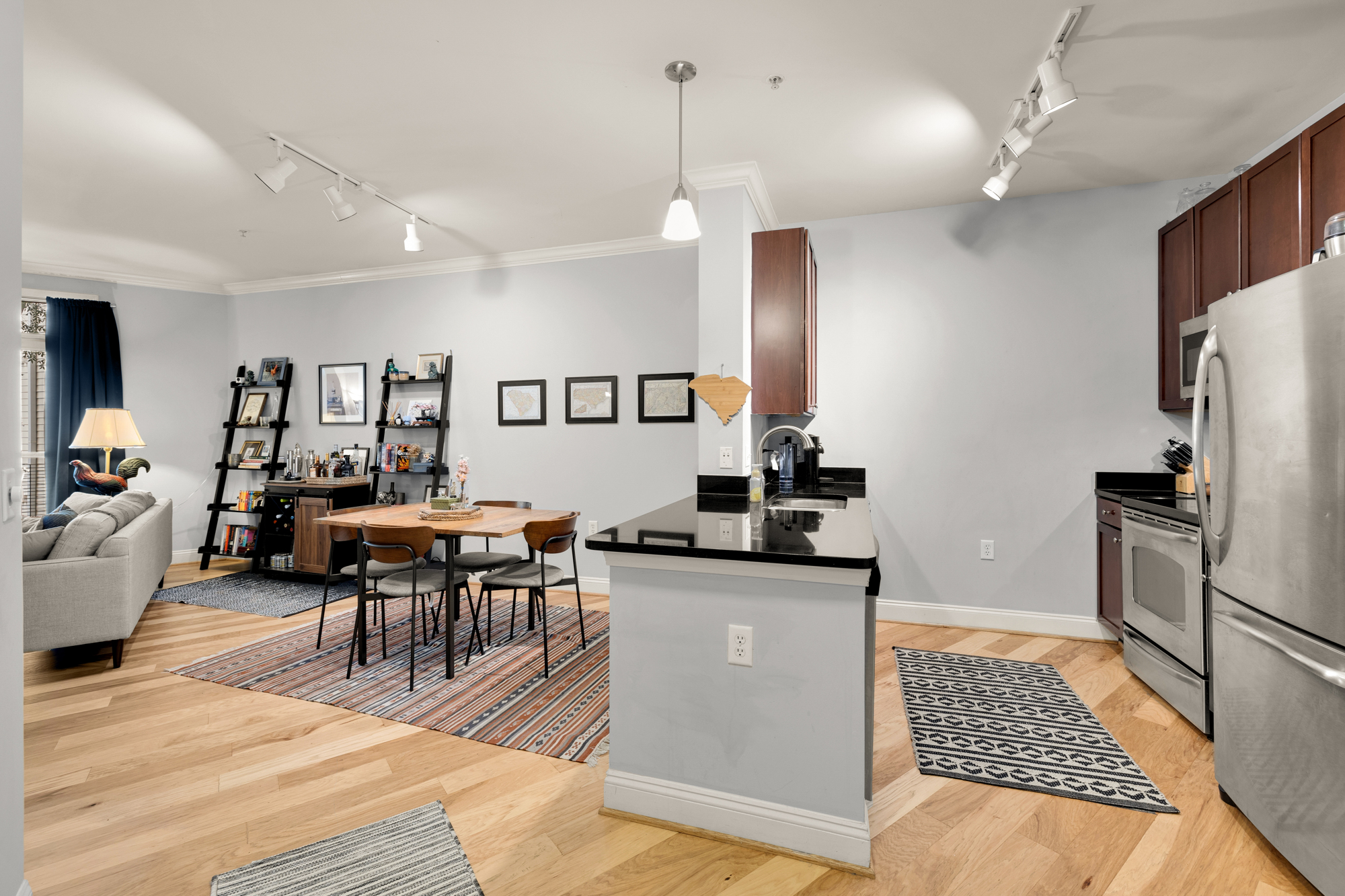 1391 Pennsylvania Ave. Southeast, Unit 324 Washington, DC 20003 - Photo 3 of 33 a kitchen with stainless steel appliances granite countertop a refrigerator a sink dishwasher a dining table and chairs with wooden floor