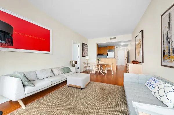 a living room with furniture kitchen view and a couch