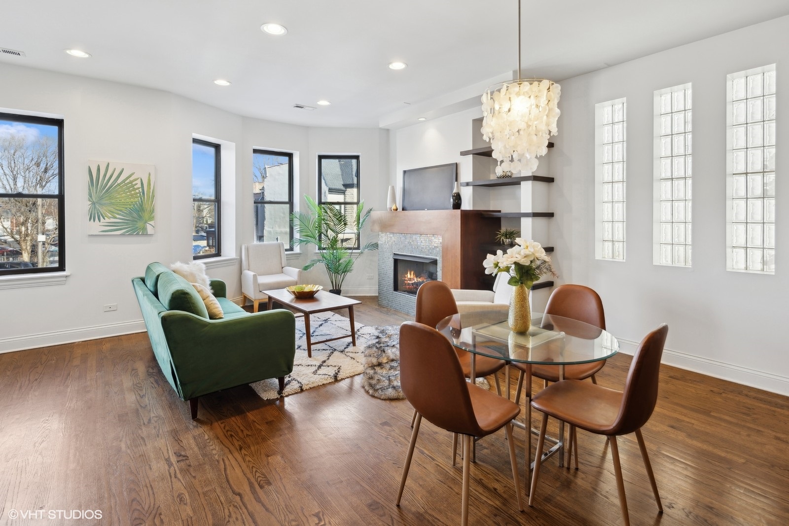 1227 East 46th Street, Unit 2E Chicago, IL 60653 - Photo 4 of 16 a dining room with furniture a chandelier and wooden floor
