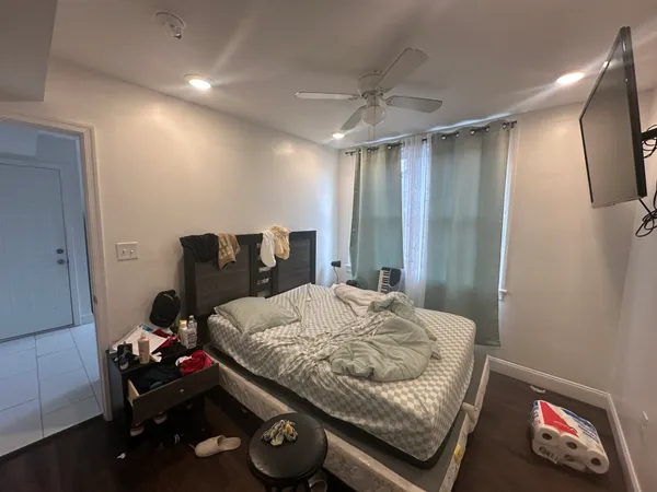 a bedroom with a bed and a mirror